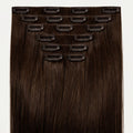 Set of hair extensions with clips on a white background